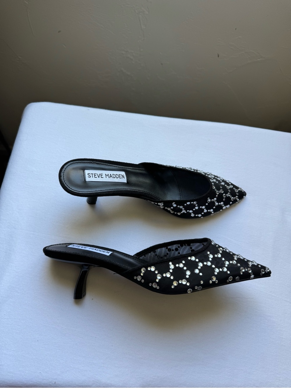 Steve Madden Micki-R rhinestone-embellished mesh kitten heel mules in black. 6